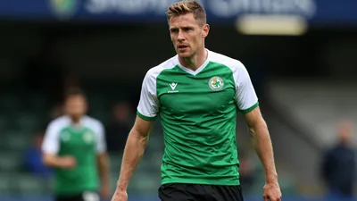 A tight action crop of a Shamrock Rovers player, aged 25-30, in a midfielder role, with a build of lean and athletic...